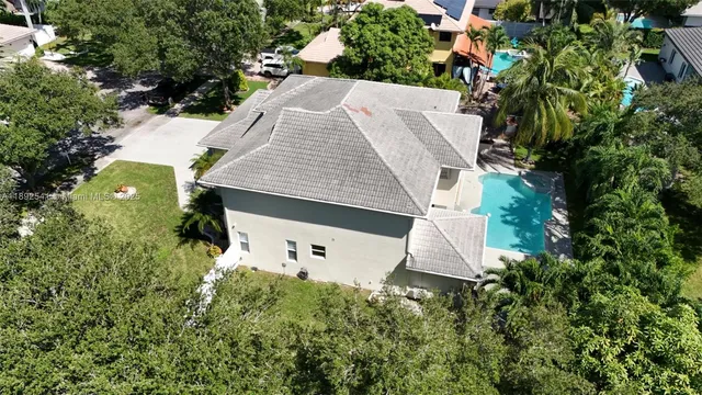 an aerial view of a house with yard and outdoor seating