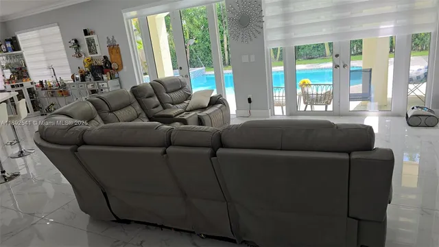 a living room with furniture and a large window