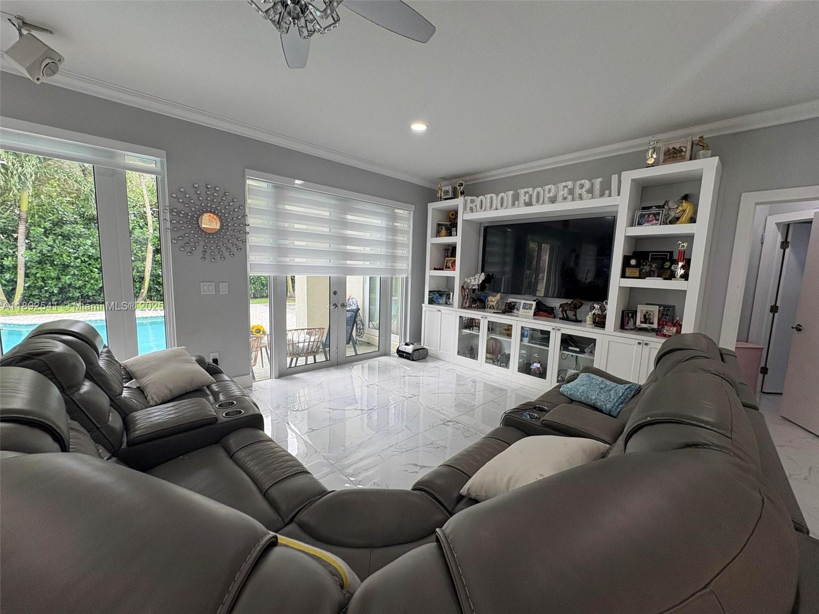 15982 Southwest 61st Street Davie, FL 33331 - Photo 9 of 28 a living room with furniture and a flat screen tv