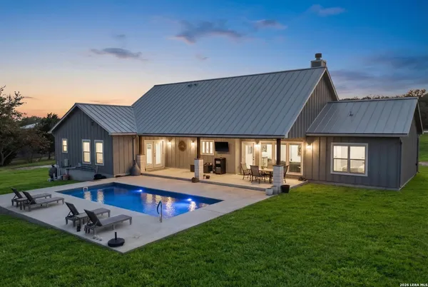 a view of a house with swimming pool and sitting area
