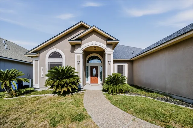 a front view of a house with garden