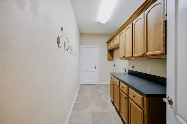 an empty room with a window and a ceiling fan