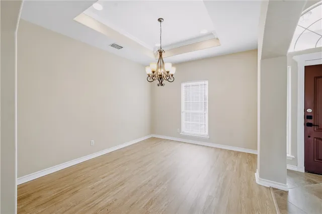 a view of a livingroom with a flat screen tv a fireplace and a ceiling fan