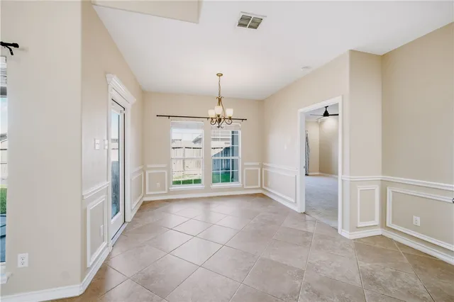 a large kitchen with cabinets and a wooden floor