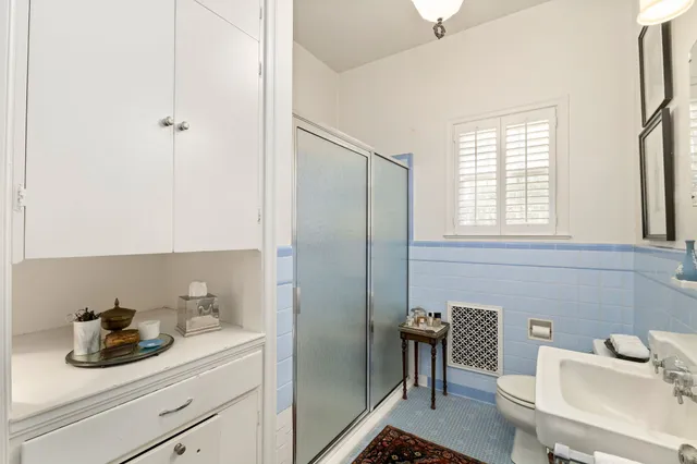 a bathroom with a sink a toilet and a mirror