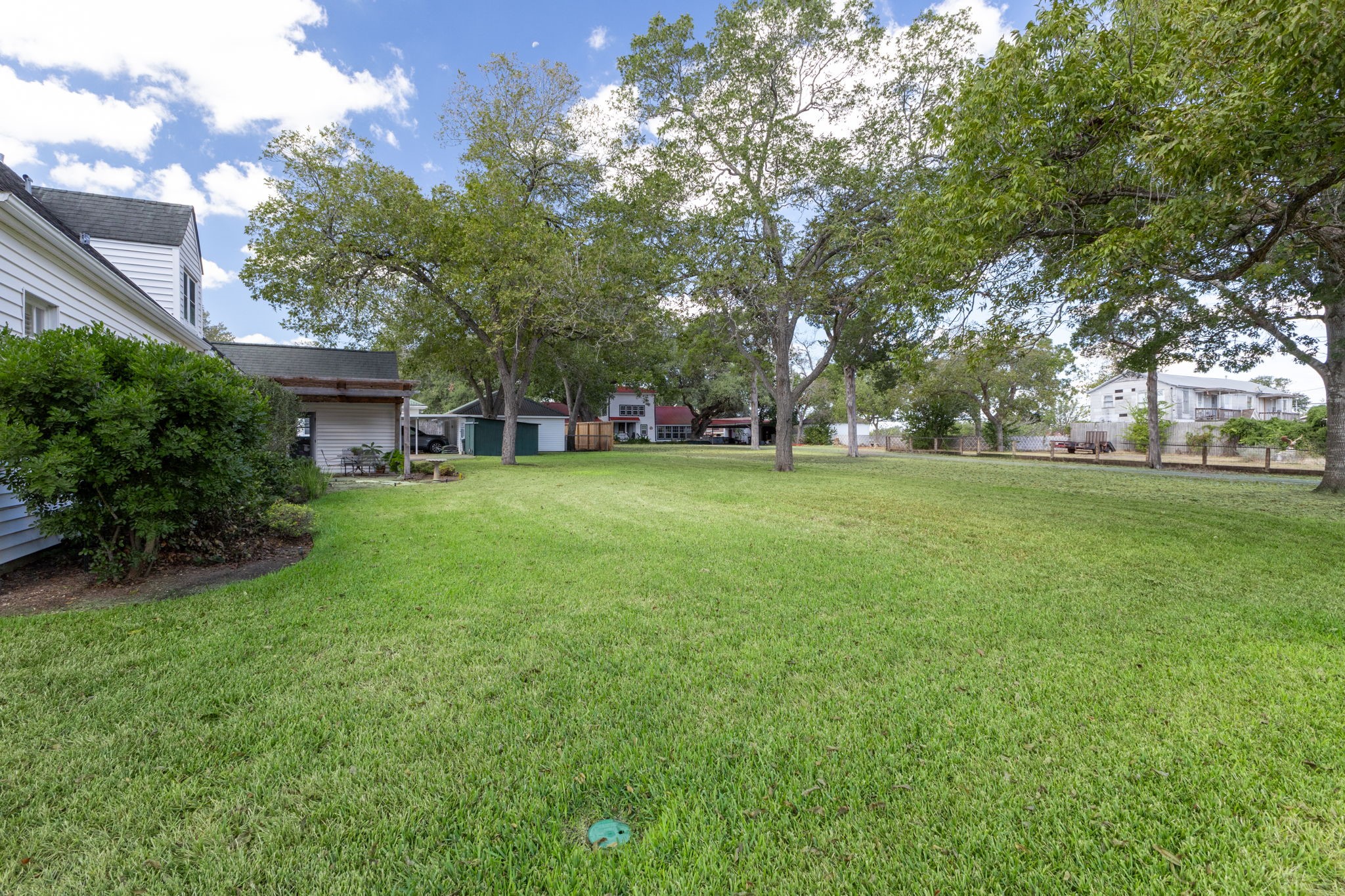 901 Anderson Street Schulenburg, TX 78956 - Photo 32 of 36 a view of a house with a big yard and large trees