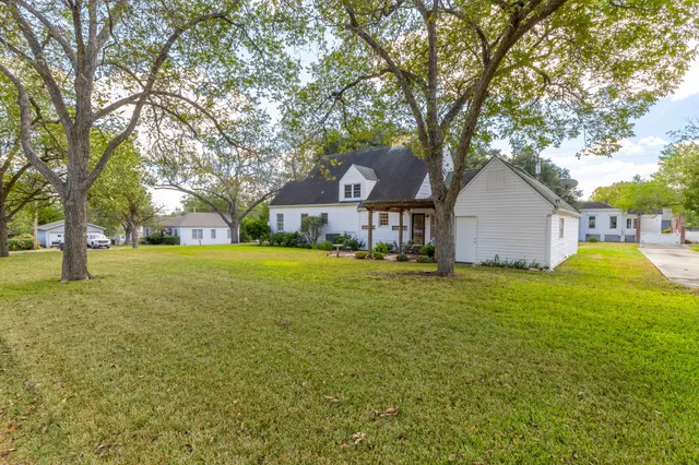 a front view of house with yard and green space