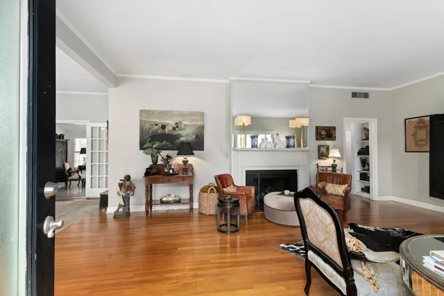 a living room with fireplace furniture and a wooden floor