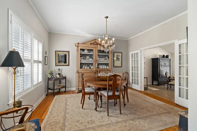 a view of a dining room with furniture and chandelier