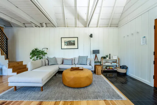 a living room with furniture and a dining table