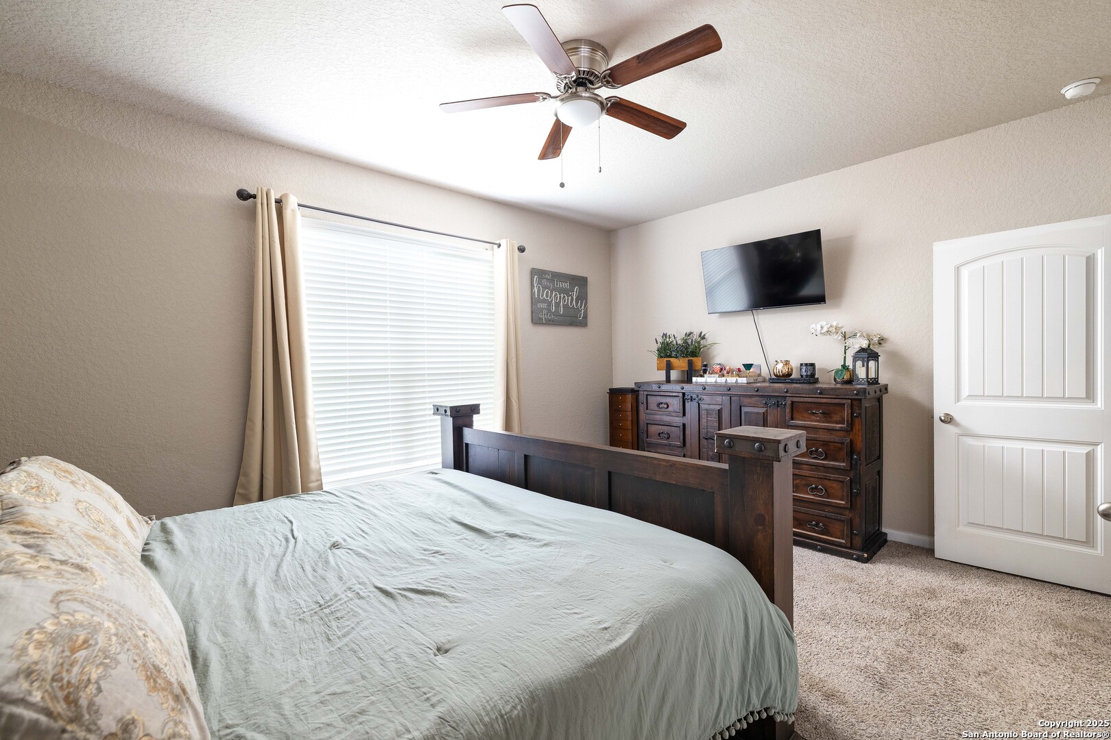 10238 Midsummer Meadow Converse, TX 78109 - Photo 15 of 35 a bedroom with a bed and a flat screen tv