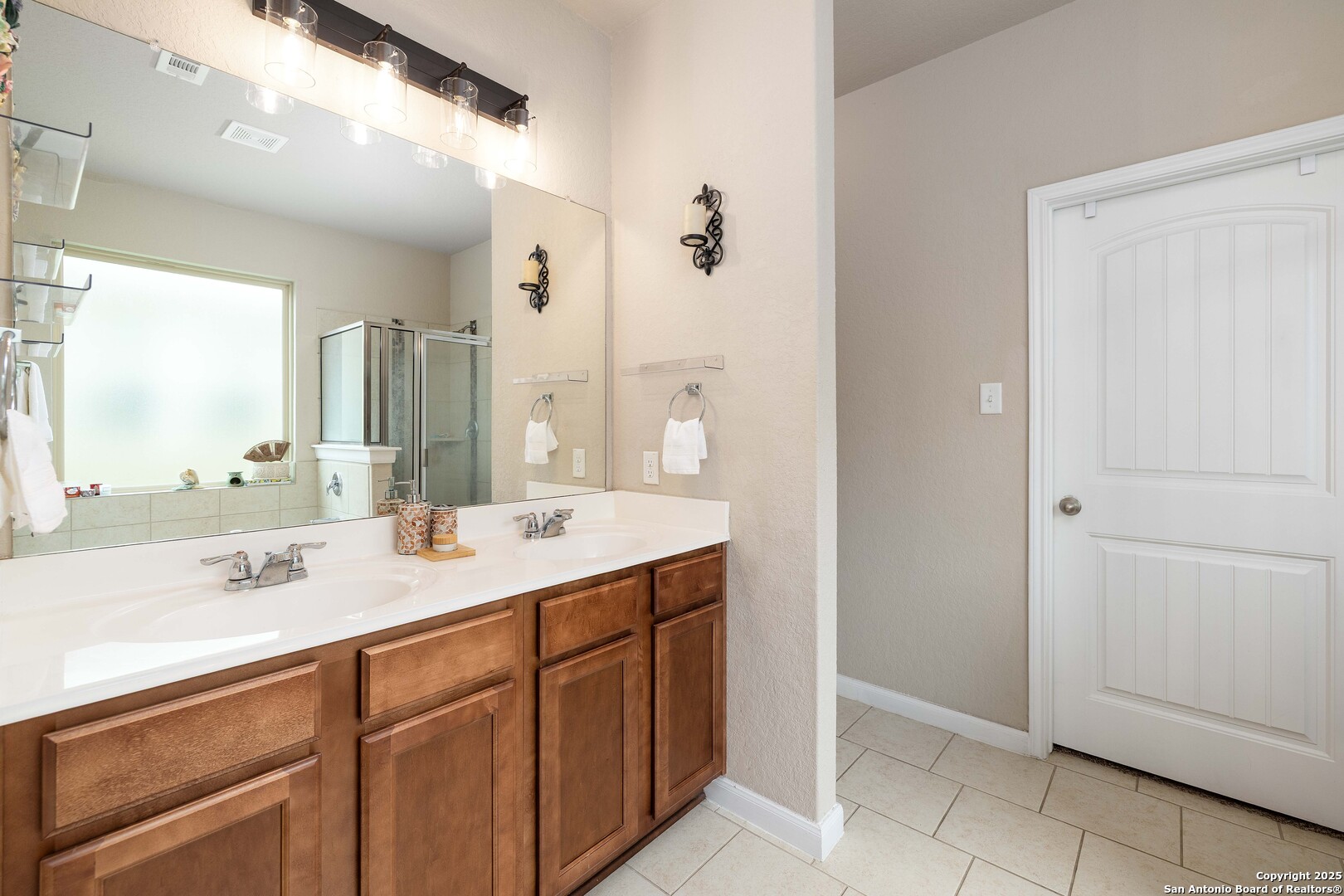 10238 Midsummer Meadow Converse, TX 78109 - Photo 16 of 35 a bathroom with a sink and a mirror