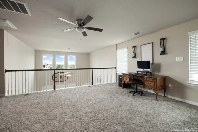 a view of livingroom with furniture window and a ceiling fan