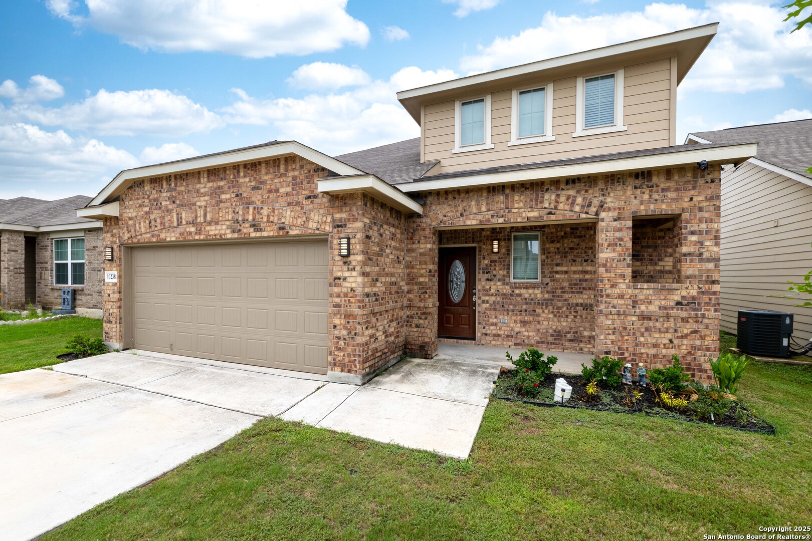10238 Midsummer Meadow Converse, TX 78109 - Photo 2 of 35 a front view of a house with a garden