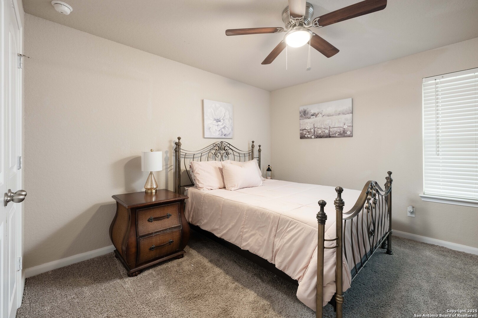 10238 Midsummer Meadow Converse, TX 78109 - Photo 22 of 35 a bedroom with a bed and a chandelier