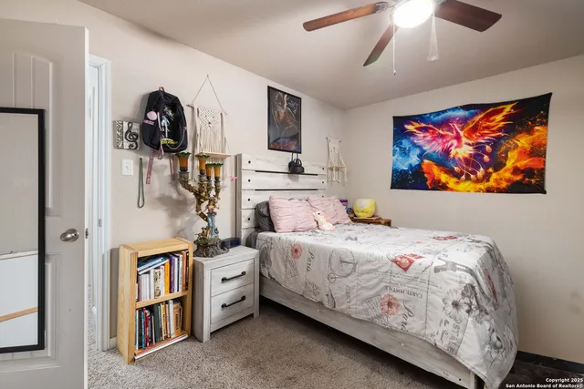 a bedroom with a bed and a painting on the wall