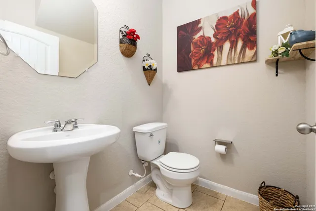 a bathroom with a toilet a sink and mirror