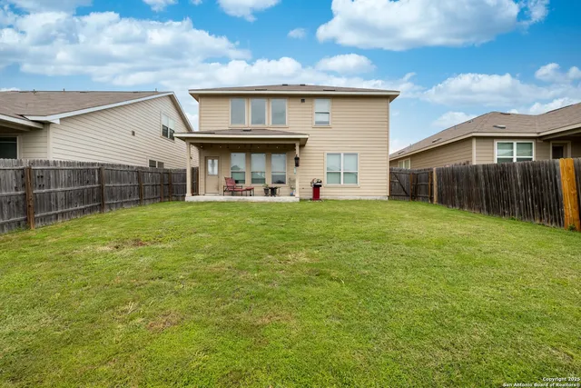 a view of a house with a yard and sitting area