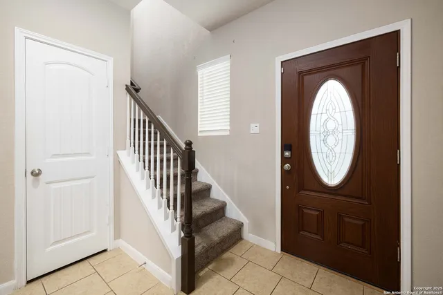 a view of a hallway with entryway wooden floor and a livingroom