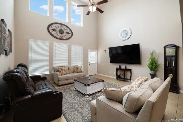 a living room with furniture a flat screen tv and a window