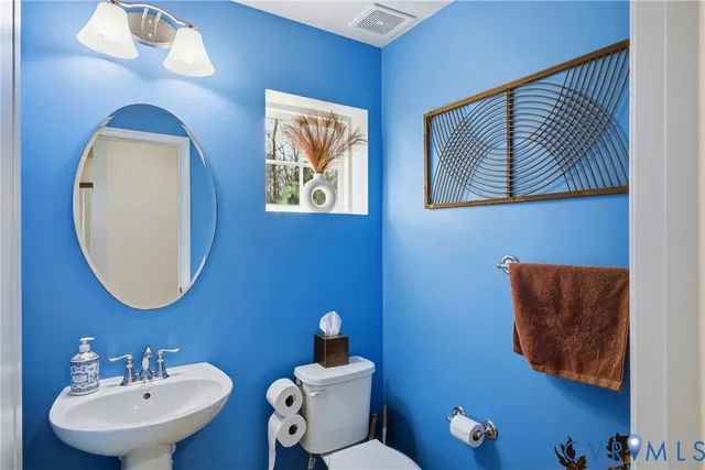 a bedroom with a bed a table and dresser