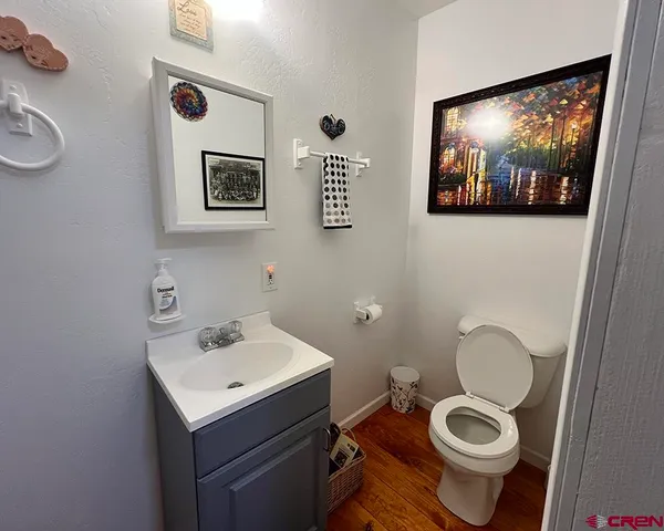 a bathroom with a toilet a sink and mirror