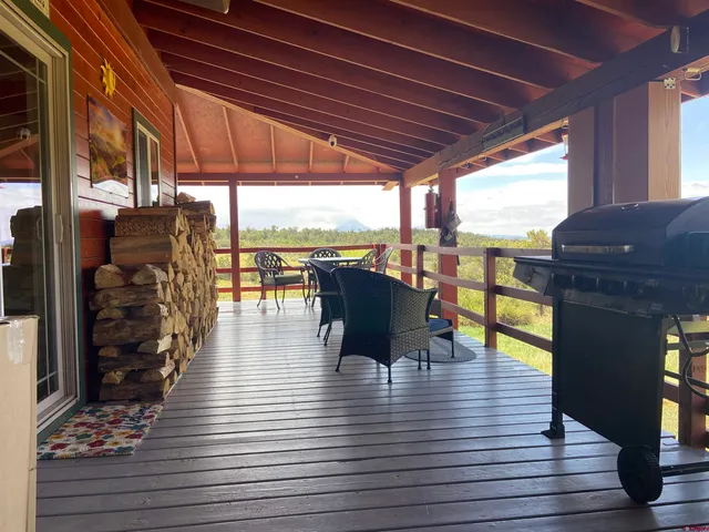 a view of a patio with dining table and chairs