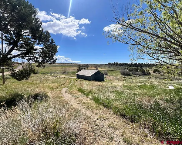 a view of a lake in the backyard of a house