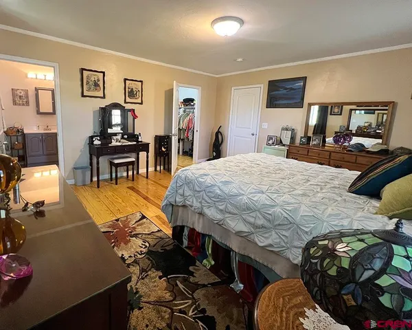 a bedroom with a bed a table and chair