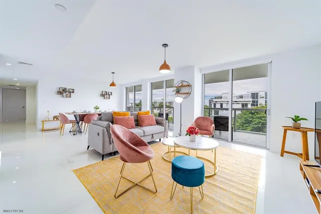 a living room with furniture a window and a table