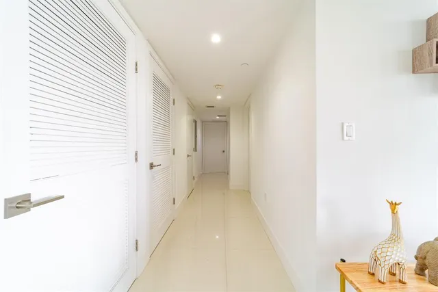a view of a hallway with a white cabinet