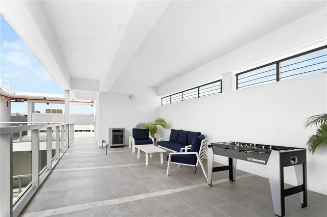 a living room with furniture and a piano