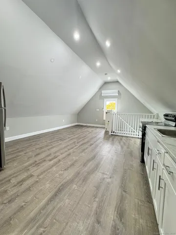 a view of empty room with wooden floor