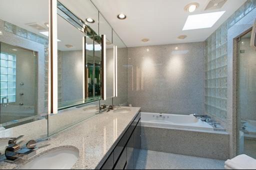 804 North Happ Road Northfield, IL 60093 - Photo 10 of 13 a bathroom with a granite countertop tub sink and mirror