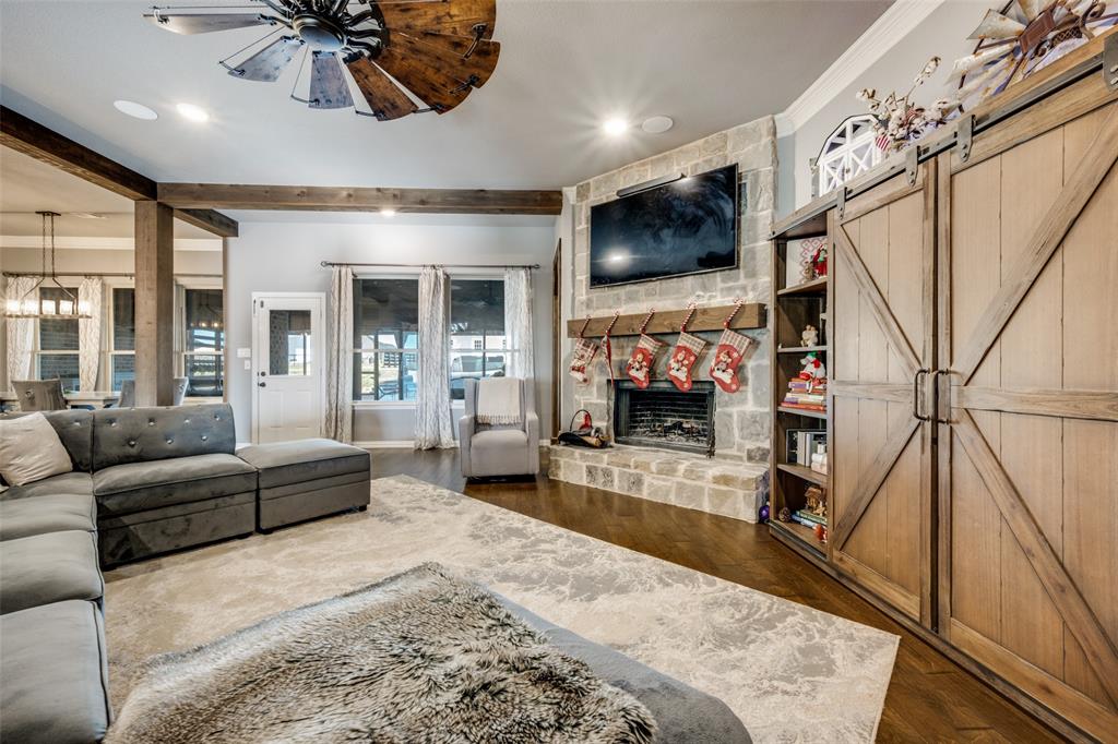 7417 Green Mesa Road Ponder, TX 76259 - Photo 7 of 39 a living room with furniture a flat screen tv and a fireplace