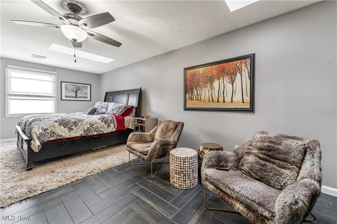 155 Ridgewood Boulevard Belpre, OH 45714 - Photo 32 of 49 Bedroom featuring a skylight, a textured ceiling, and ceiling fan