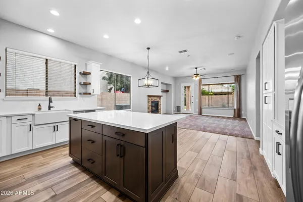 a spacious kitchen with stainless steel appliances granite countertop a sink and dishwasher with white cabinets