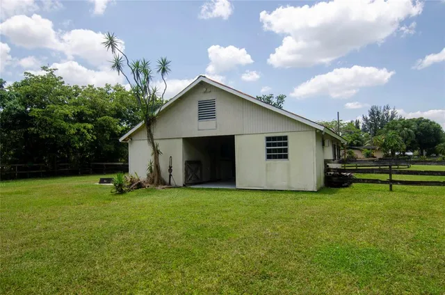 a view of backyard of house and deck