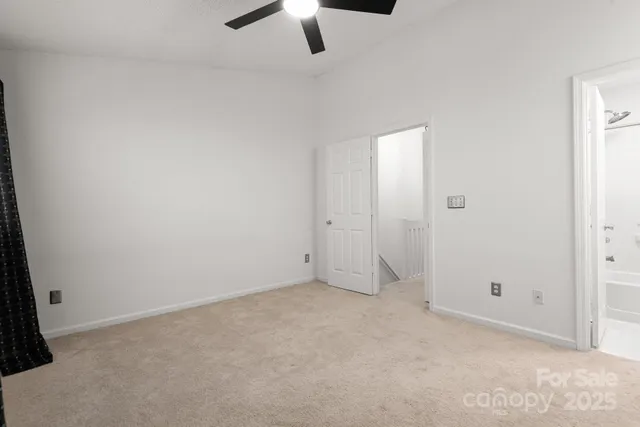 an empty room with view of a bathroom