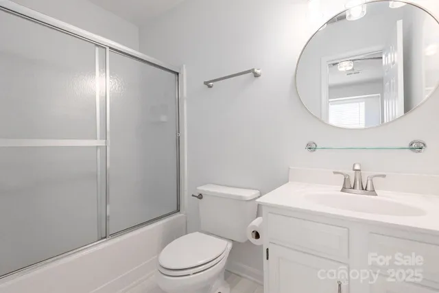 a bathroom with a toilet a sink and a mirror