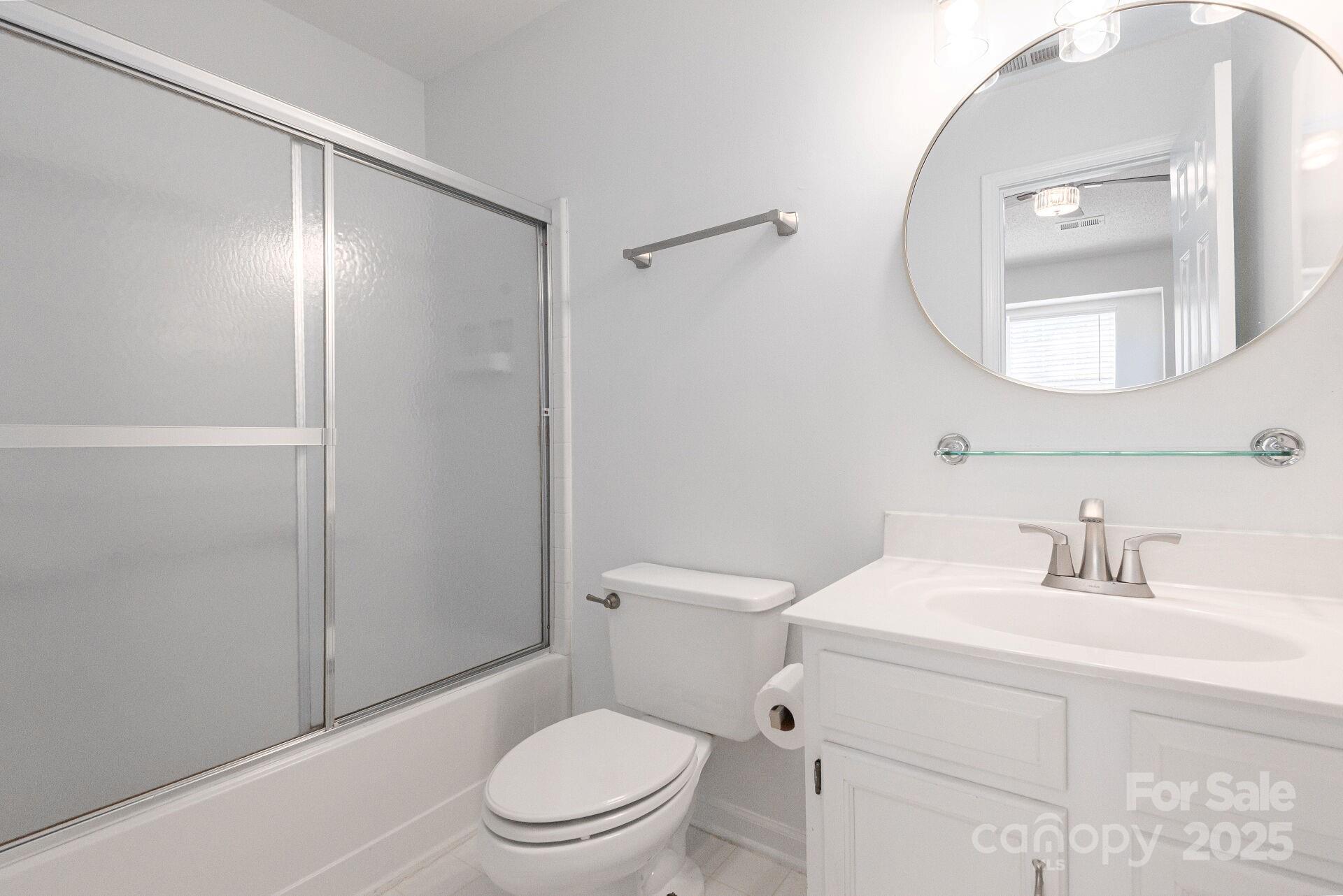 9204 4 Mile Creek Road Charlotte, NC 28277 - Photo 15 of 18 a bathroom with a toilet a sink and a mirror