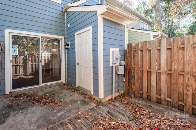 a view of a backyard with wooden fence