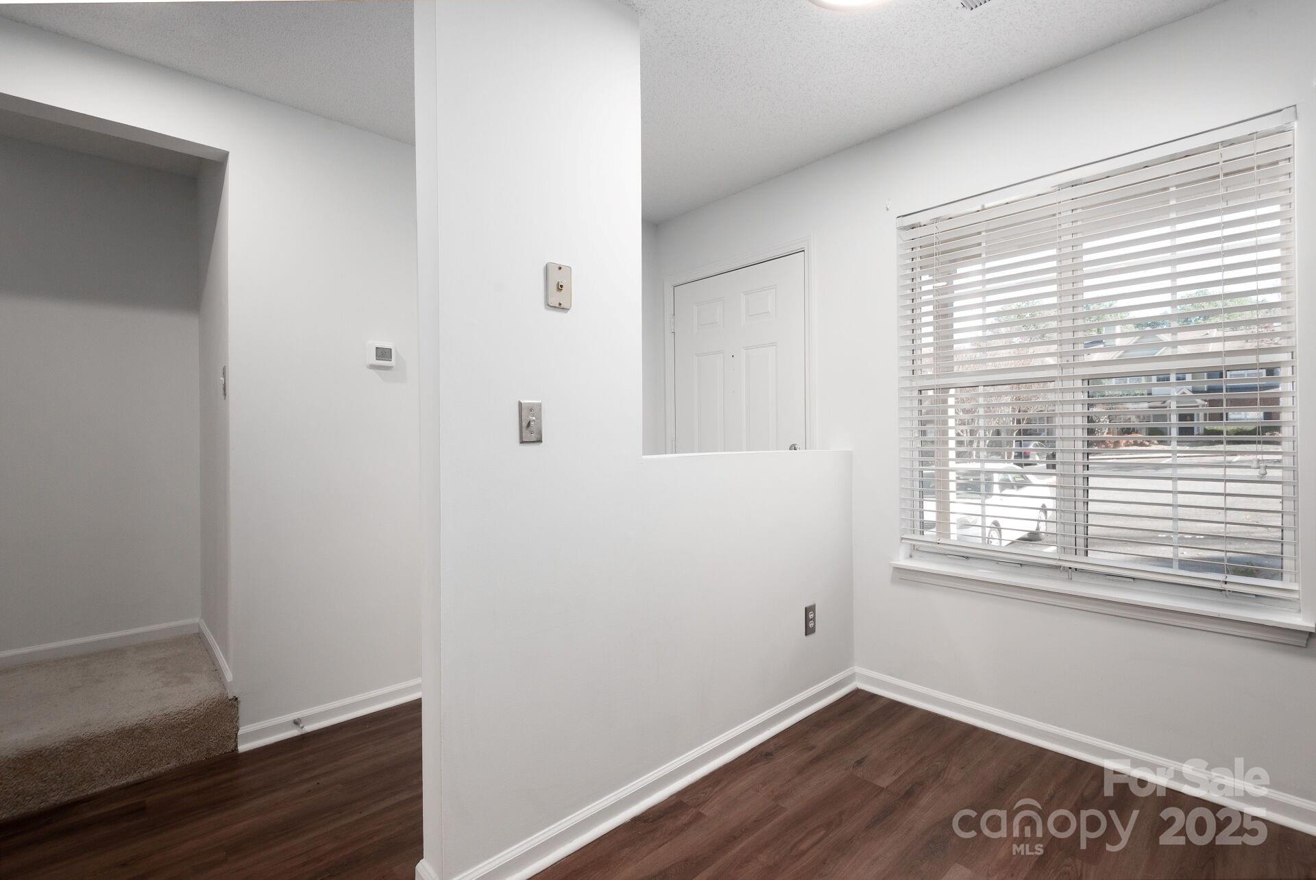 9204 4 Mile Creek Road Charlotte, NC 28277 - Photo 2 of 18 a view of a small space with wooden floor and a window