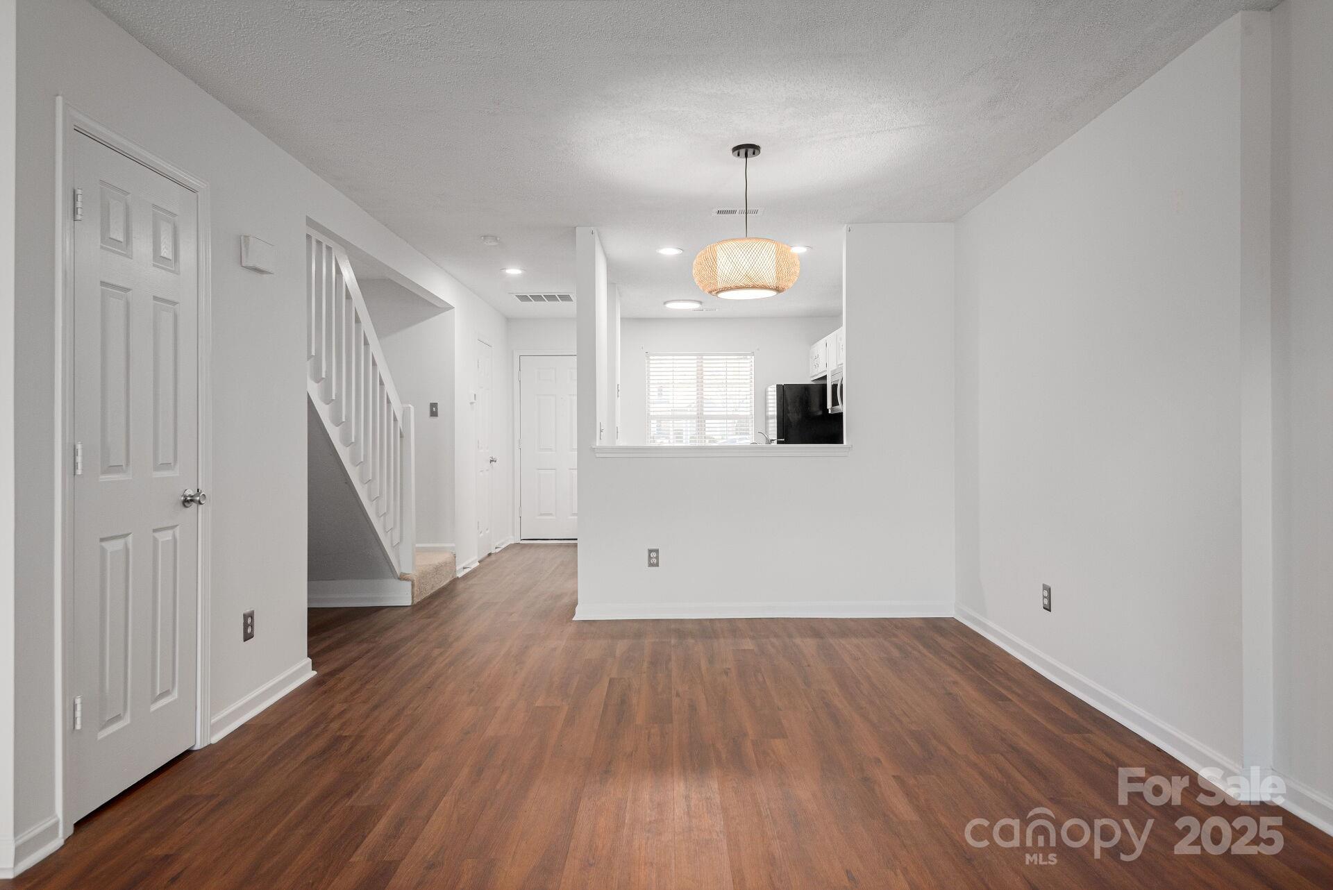 9204 4 Mile Creek Road Charlotte, NC 28277 - Photo 3 of 18 an empty room with wooden floor and windows