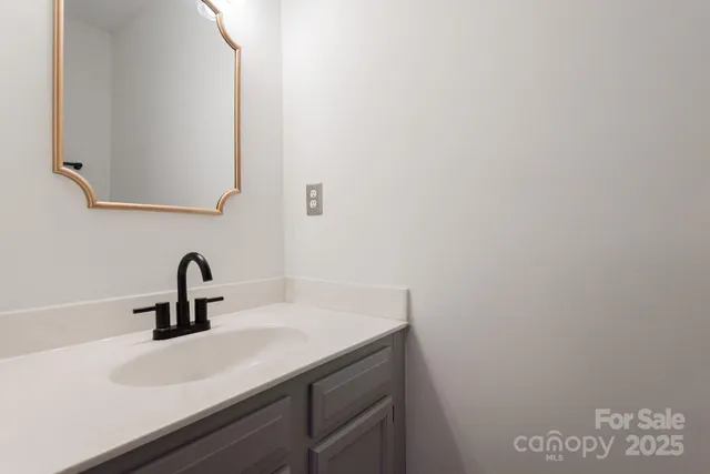 a bathroom with a sink and vanity