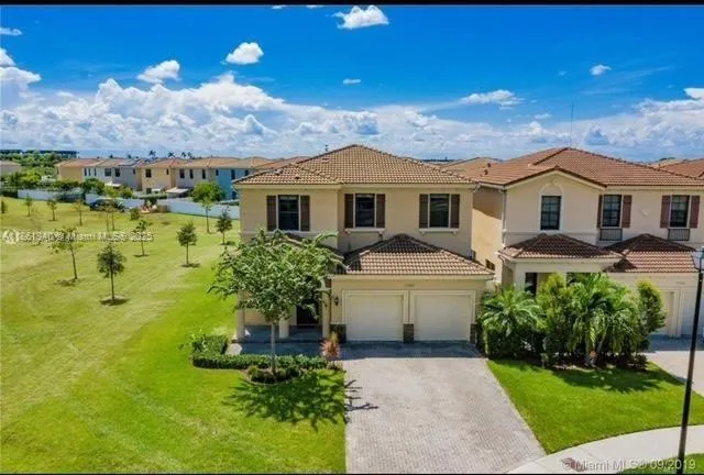 a front view of houses with yard