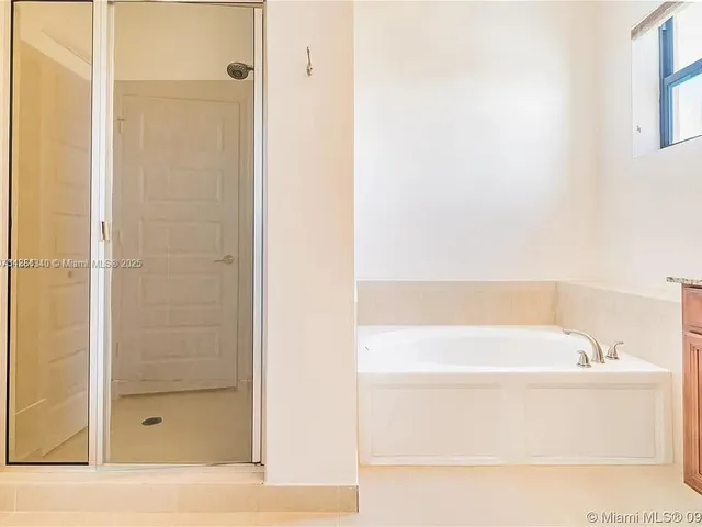 a bathroom with a bathtub and shower