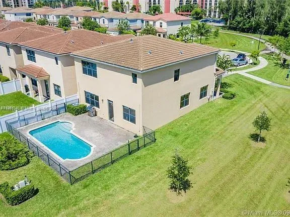 a aerial view of a house with table and chairs