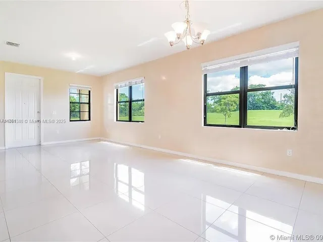 a view of a livingroom with a ceiling fan and window