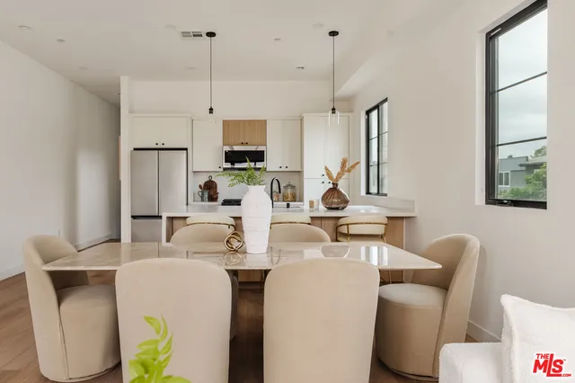 a living room with furniture a flat screen tv and a large window